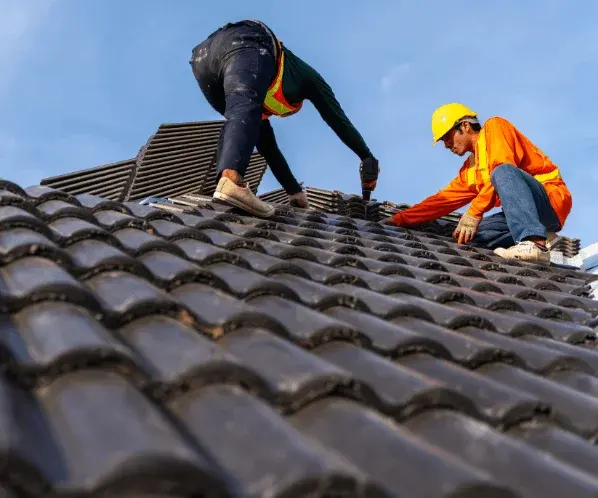 Tradie working on a roof at dusk